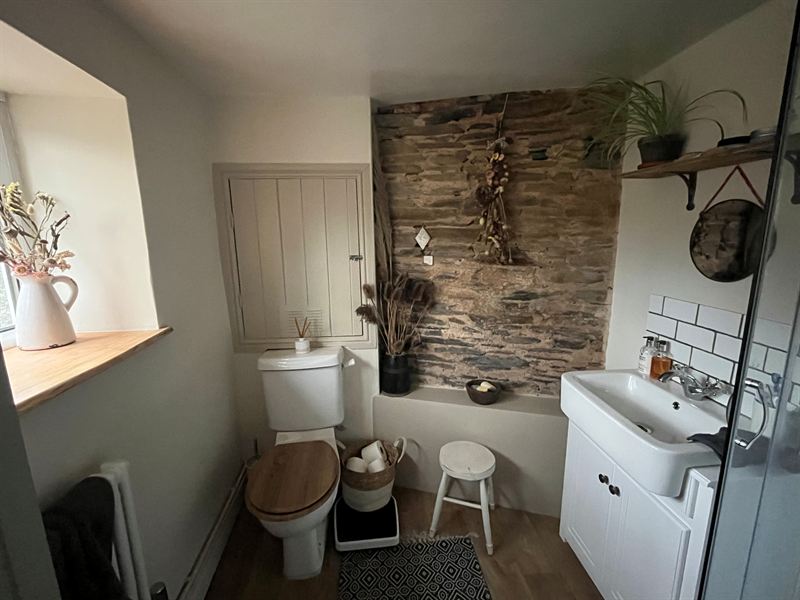 Bathroom with a reclaimed wood feature wall and white panelling