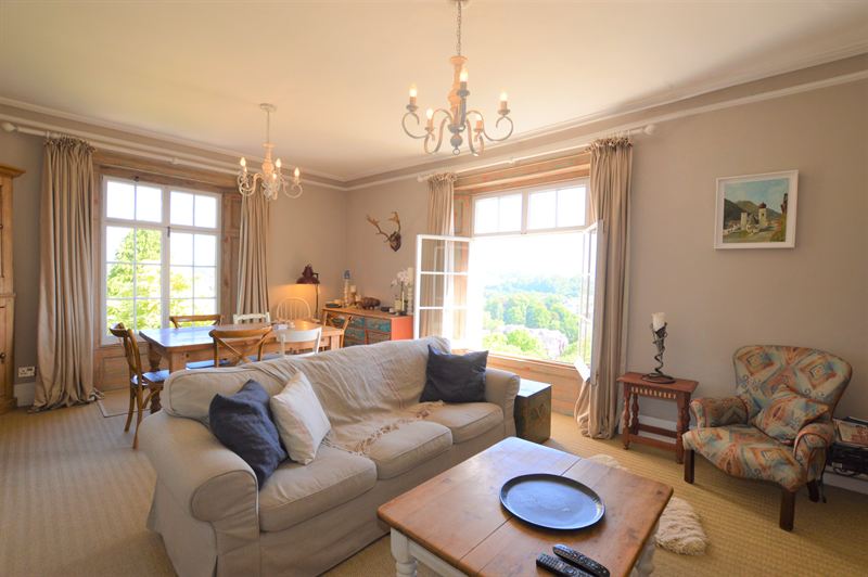 Light, neutral lounge with tall windows